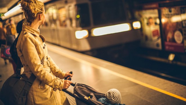 mom with stroller waiting for the train