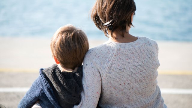mother and son hugging on the beach