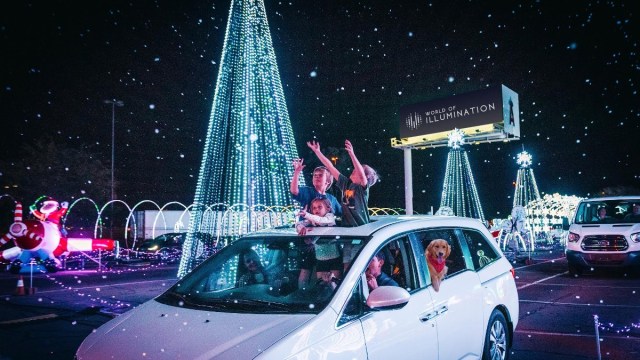 people in a car, standing through the sun roof, drive through Chistmas lights atlanta display world of illumination reindeer run