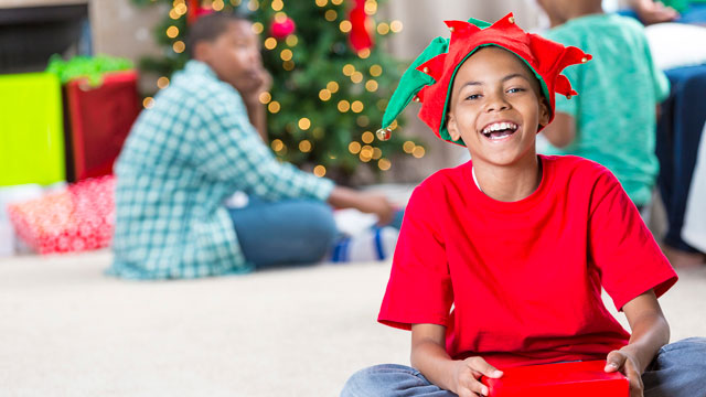 little boy laughing at Christmas jokes, elf jokes, and santa jokes