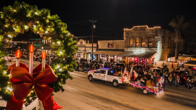 A decorated vehicle driving down a parade route