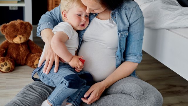 pregnant mom holding a toddler