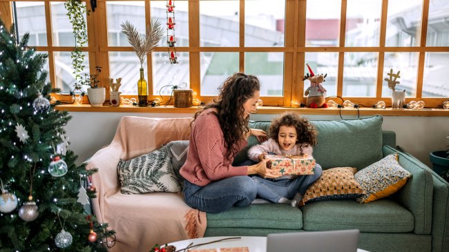 single mom opening Christmas gifts with her daughter