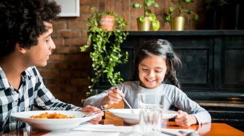 a parent and child share a meal at a family restaurant boston