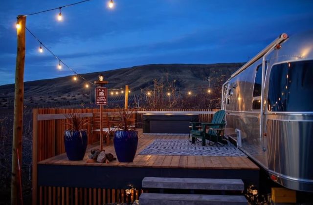 airstream trailer with deck in desert at night