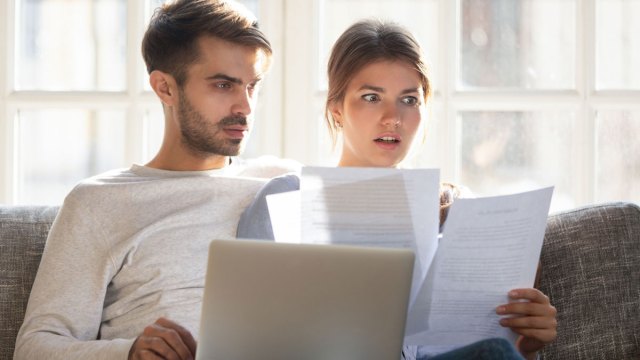 upset woman looking at papers