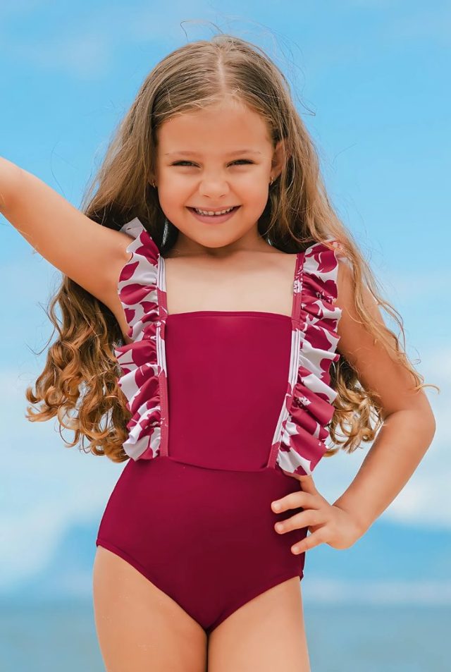 child wearing the swimsuit on the beach