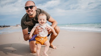 dad with baby at the beach needs to know about some baby beach essentials