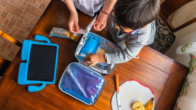 kid with open lunchbox