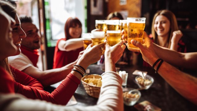people drinking at a bar during happy hour