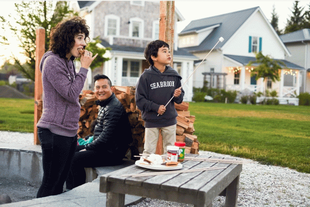 a family sits around a firepit at Seabrook, a town on the Pacific that's a good weekend trips from seattle