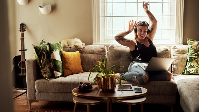 moms who do less are happier, like this woman who is listening to music and enjoying alone time. She's not apologizing