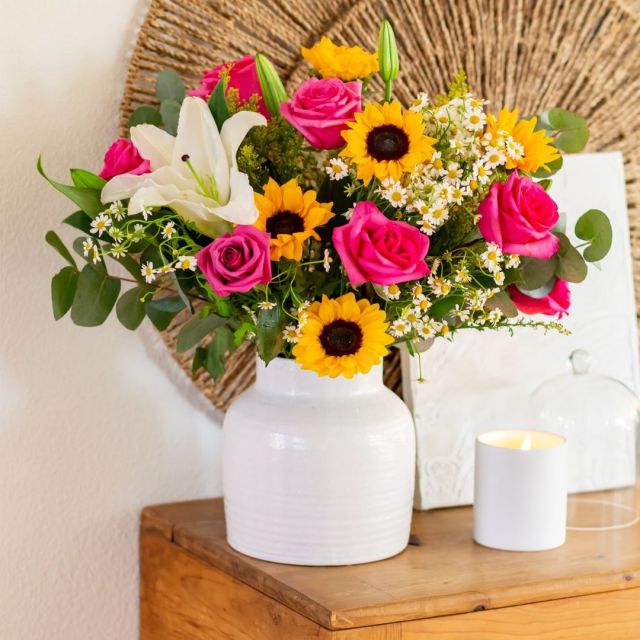 bouquet of assorted flowers in white vase