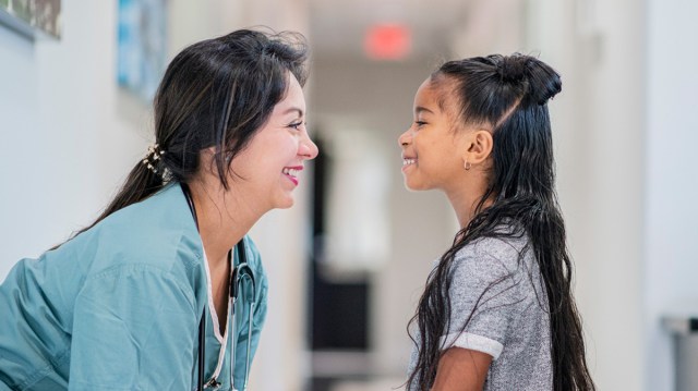 doctor prepping a little girl for a medical procedure