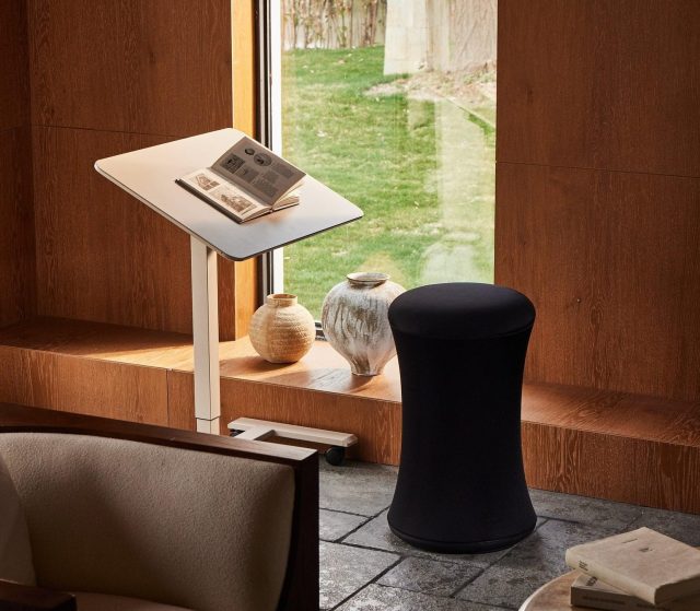 an adjustable desk and modern stool