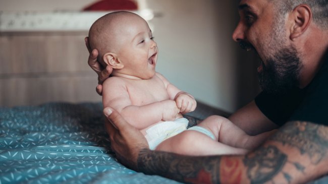 dad holding baby in his arms