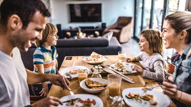 a family having lunch and asking would you rather questions for kids