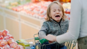 toddler having a tantrum in a grocery store