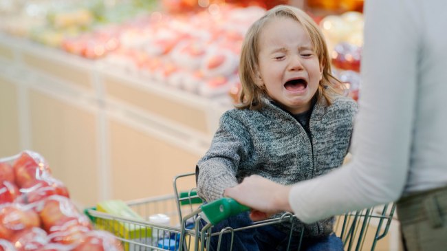 toddler having a tantrum in a grocery store