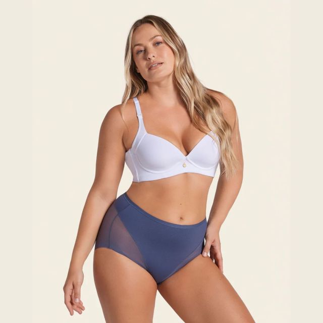 most comfortable women's underwear blonde woman standing posed in white bra and dark blue shaping underwear