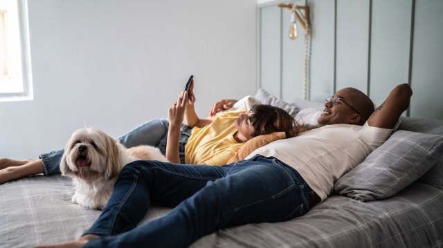 man and woman hanging out in their bedroom