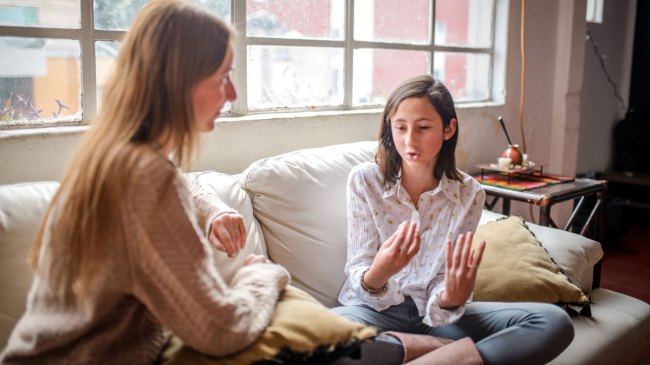 mom talking to her daughter on the couch