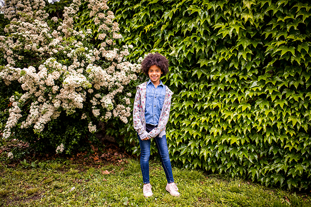 posing in front of greenery is one of our favorite first day of school picture ideas