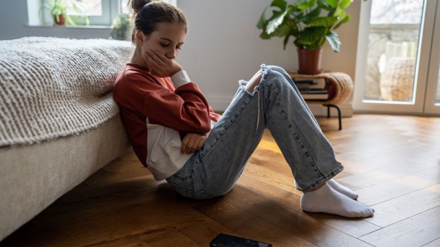 upset girl looking at a 'lala bop' tiktok video