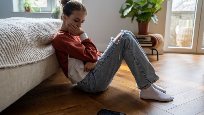 upset girl looking at a 'lala bop' tiktok video