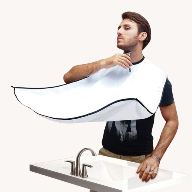 man using beard trimmer beard