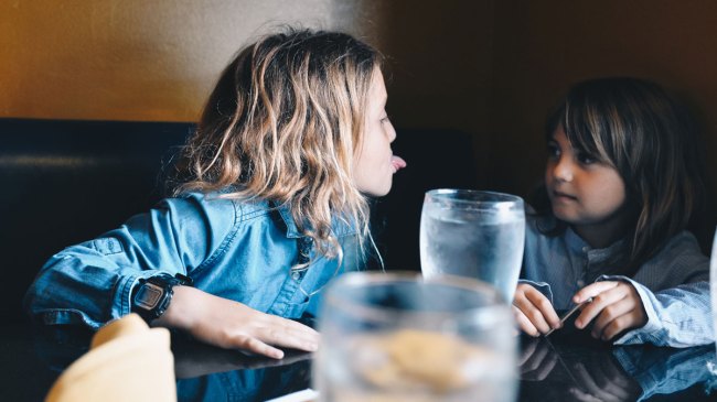 two kids misbehaving in a restaurant