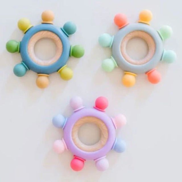 three colorful round teething rings