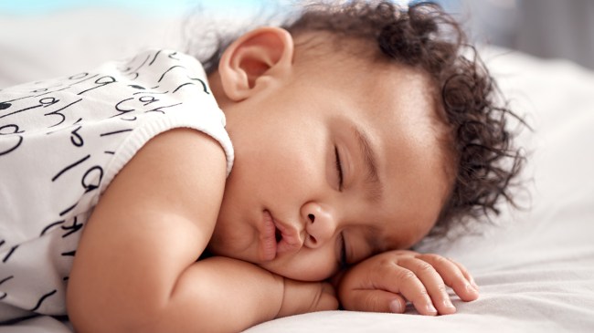 a toddler sleeping on their tummy for a story about when babies can sleep on their stomach