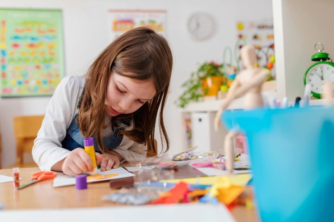 girl doing an art project at home