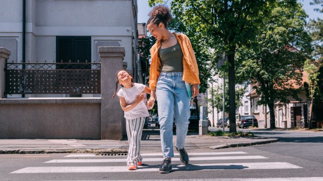 girl walking and laughing with mother