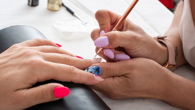 woman getting a salon manicure