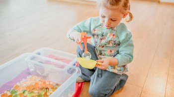 a girl playing with water beads, one of the most dangerous toys according to pediatric ER docs