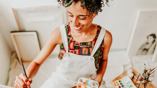 mom painting and smiling