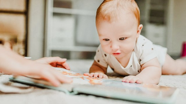 A parent reading to their baby for a story on the best way of reading to babies to make sure they're engaged