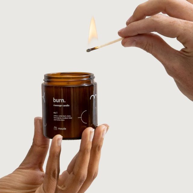 hand holding candle and lit match