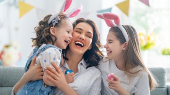 a picture of a mom and her daughters laughing at Easter jokes