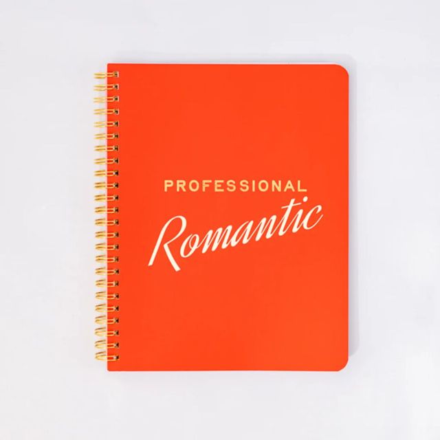orange notebook with Hopeless Romantic text across cover