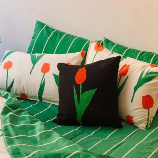 pillow printed throw pillow and sheets on bed