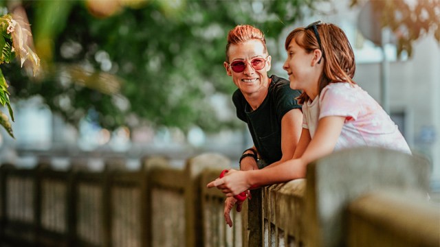 mother and daughter talking on bridge
