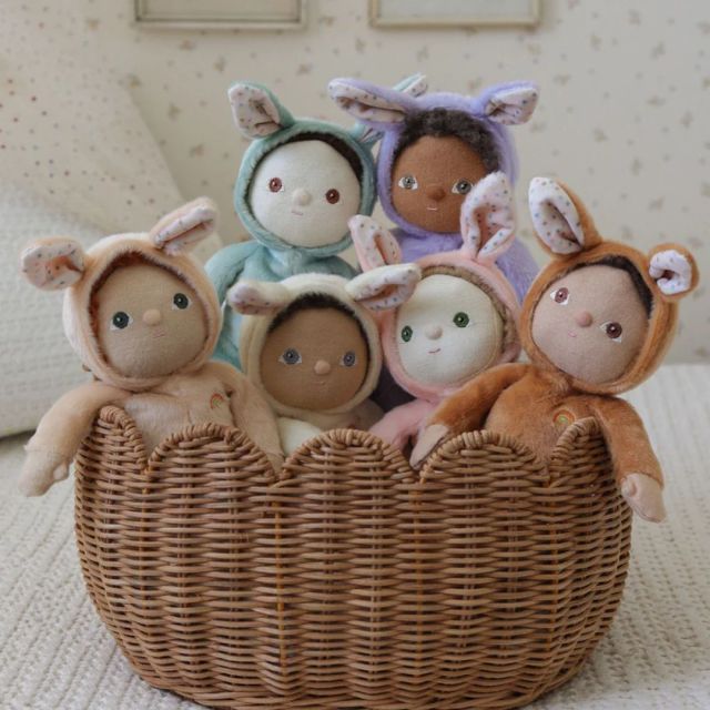 basket full of six different baby dolls for toddlers dressed in bunny outfits