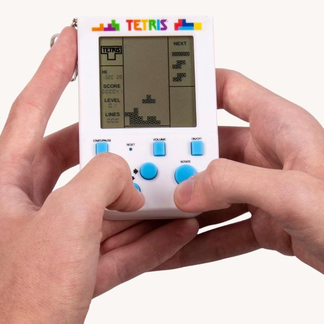 hands holding mini Tetris game keychain