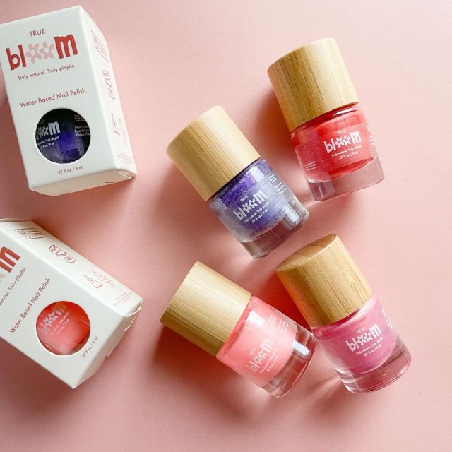 four bottles of True Bloom nail polish for kids in various colors