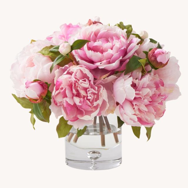 faux peonies in glass vase