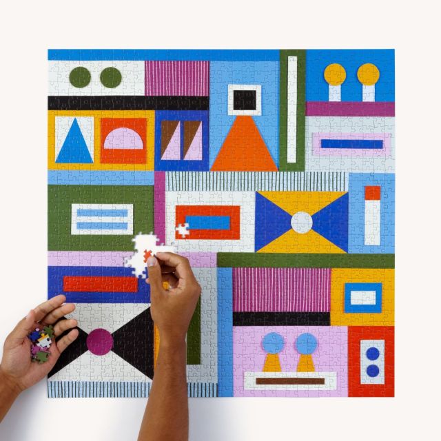 hands finishing the puzzle