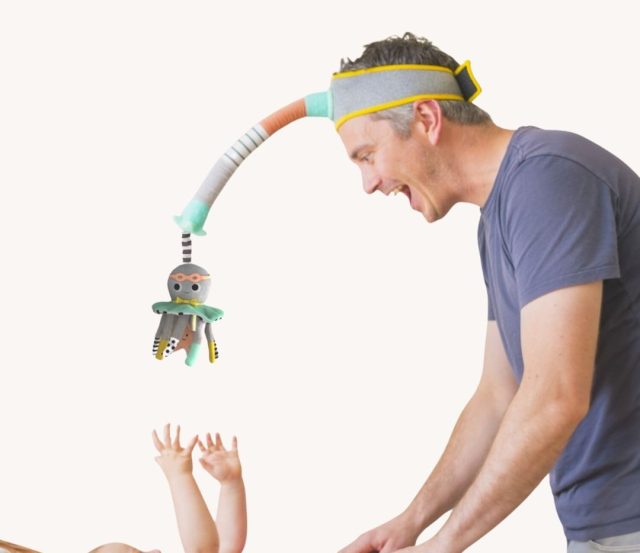 father with dingle dangle baby toy